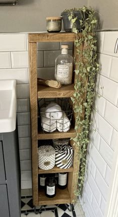 the bathroom is decorated with white and black accessories, such as soaps, toiletries, and plants