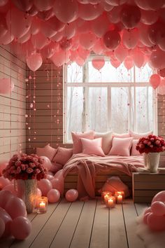 a room filled with lots of pink balloons and candles next to a bed covered in pillows