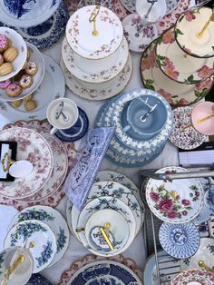 a table topped with lots of plates covered in different types of dishes and saucers