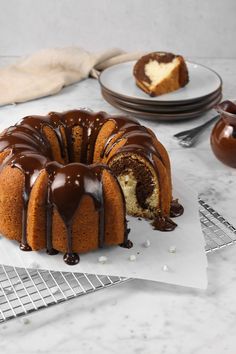 a chocolate marble pound cake on a cooling rack with one slice cut out and the rest half eaten