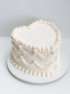 a wedding cake with white frosting and beaded decorations