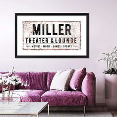 a living room with purple couches and white vases on the table in front of it