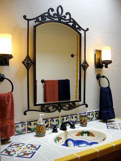 a bathroom with a sink, mirror and towel rack