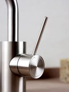 a stainless steel sink faucet with two handles