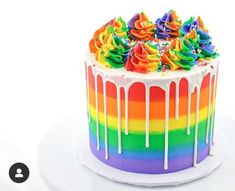 a rainbow cake with icing and sprinkles