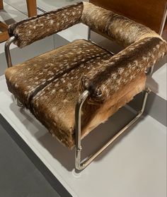 a chair that has some kind of animal print upholstered on it's back