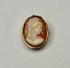 This listing is for a wonderful 12k gold cameo brooch pendant as shown in the photos. Crafted of carved shell with a solid 12k (hallmarked 500 as shown) gold bezel. The pin measures approximately 1.25" x .75" and the weight is approximately 6.34 grams. Comes with a nice gift box. US shipping includes insurance and tracking.  International shipping includes insurance/tracking to ensure safe delivery. I automatically refund any overages in shipping charges and happily combine shipping where I'm ab Classic Gold Brooch With Intaglio Detail, Classic Gold Intaglio Brooch, Classic Gold Intaglio Brooches, Classic Gold Brooches With Intaglio, Carved Yellow Gold Brooches For Wedding, Heirloom Yellow Gold Cameo Brooches, Victorian Cameo Brooch In Yellow Gold, Victorian Cameo Brooches In Yellow Gold, Victorian Yellow Gold Cameo Brooches