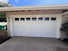 a white garage door in front of a house