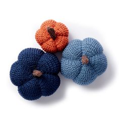 three crocheted pumpkins sitting next to each other