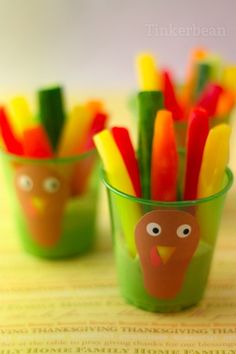 colorful plastic cups with turkey and carrot sticks in them