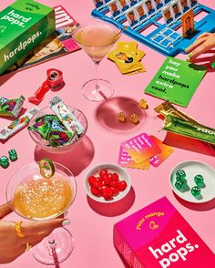 a pink table topped with lots of candy and drinks