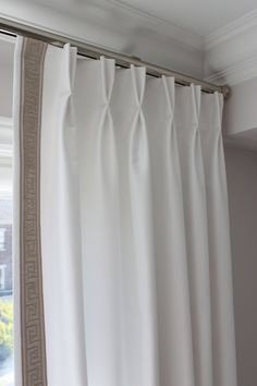 a white curtain hanging in front of a window