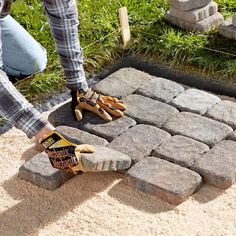 a person is placing bricks on the ground