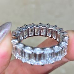 someone is holding a ring made out of diamonds