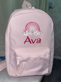 Our New Range of Beautifully Embroidered Backpacks in a range of colours  Personalised with design and first name in any colour thread. Backpack Size : 35 x 23 x 12 cm Capacity : 7 litres There are 4 different colours available, and all have: Grab handle. Padded adjustable shoulder straps. Padded back panel. Main zip compartment. Front zip pocket The bag can either be embroidered with just the name in a choice of fonts and colours, or with the large size initial and name in a choice of colour. S School Backpack With Embroidered Logo, Pink Embroidered School Bag, Pink Embroidered School Bags, Embroidered Backpack For Students, Embroidered Standard Backpack For Students, Embroidered Student Backpack, Student Embroidered Standard Backpack, Embroidered Standard Backpack, Cute Embroidered Backpack For School