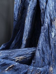 a blue chair covered in plastic sitting next to a wall