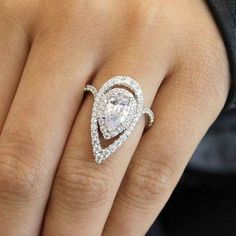 a woman's hand with a diamond ring on her finger and an engagement band