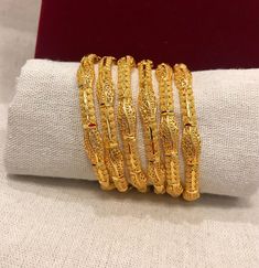 Christmas Gift, Holiday Gift,  24k gold plated Bangles, Indian Bridal Bangles, Handmade Bracelet for Women Gold Bangles for Women - Indian Bridal Bangles - Handmade Bracelet These stylish bangles feature a classic bangle design and are available in gold color. ▶ BEAUTIFUL HINGED GOLD BRACELET ▶ HIGED TO OPEN WIDE----- STAYS SECURELY SHUT -----  LIFT TAB SIDE TO OPEN Material: High quality 24k gold plated bangles ( Not solid gold) Diameter: 2.36 inches Can open Lead & Nickel free Tarnish resistan Gold Bracelets For Festive Occasions, Gold Plated Temple Jewelry Bracelets, Gold Bangle With Gold Beads, Gold Plated Bracelets For Puja And Festivals, Gold Bangle For Puja And Festivals, Gold Temple Jewelry Bracelets For Puja, Gold Bracelets With Intricate Design For Puja, Traditional Gold Bracelet For Puja, Festive Yellow Gold Plated Bracelets