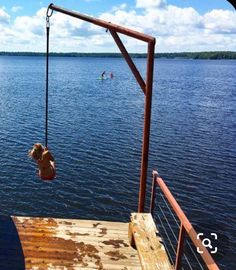 a person hanging from a rope over the water