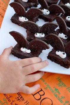 a child's hand reaching for some halloween treats