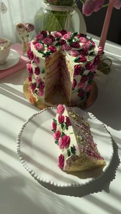 a white plate topped with a cake covered in pink flowers