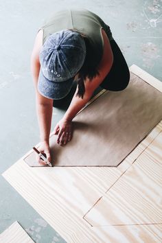 a person kneeling on top of a wooden floor