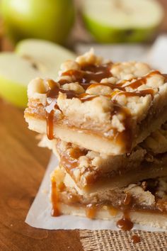 three pieces of caramel apple pie sitting on top of each other next to an apple