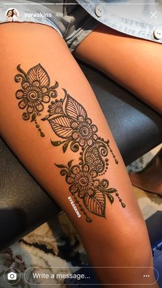 a woman's leg with henna tattoos on it