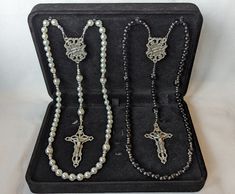 The perfect gift for that special couple! Two gorgeous handmade rosaries with matching "wedding ring" center pieces. Ideal for wedding or anniversary gifts. These beautiful, high-quality rosaries will be cherished for a lifetime. Rosary set comes in a padded, felt gift box! Hail Mary Beads - 6mm white or black pearls Our Father Beads - 8mm white or black pearls with silver bead caps Spacer Beads (White rosary) - 3mm clear crystals & 3 mm white pearls Spacer Beads (Black rosary) - 3mm corrugated White Rosary, Wedding Rosary, Black Rosary, Matching Wedding Rings, Felt Gifts, Rings Unique, Black Pearls, Hail Mary, Center Pieces