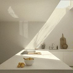 a bowl of fruit sitting on top of a white counter