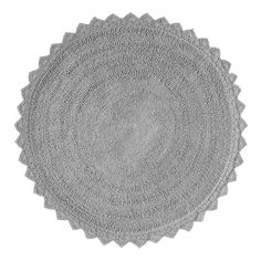 two round rugs on top of each other, one in grey and the other in white