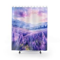 a shower curtain with lavender flowers in the foreground and mountains in the distance behind it