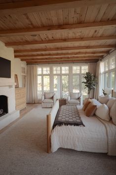 a large bed sitting in a bedroom next to a fireplace