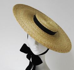 Montpellier Vogue Hat Stunning luxury handmade boater in natural fine grade braided straw. Tidy classic, with shallow crown, hand finished steel wired 18 brim and long double sided chichi velvet ribbon ties. Appropriate wear for all of your most important dressy occasions. A stylish compliment to 1950s Hats, 1950s Hat, Boat Hat, Straw Boater Hat, Straw Boater, Boater Hat, Love Hat, Wearing A Hat, Royal Ascot