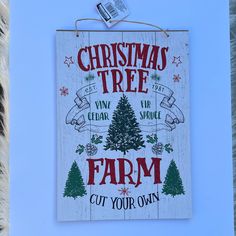 a christmas tree farm sign hanging on a wall