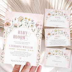 a hand holding up a baby shower card with flowers on it and the words, baby bloom