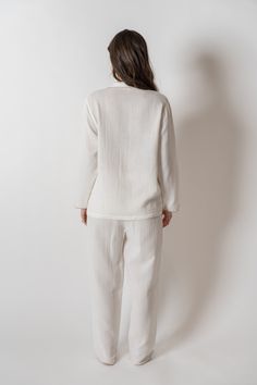 Made with 100% organic combed cotton, the Alaia Pajama Set is stylish, comfy, and sustainable, making them the perfect addition to any sleepwear collection. With a unique scalloped trim for a touch of sophistication. Features-Relaxed silhouette long sleeve-Button front-One chest pocket-Scalloped edges at the sleeve and bottoms-Drawstring waist Please Note: Monogrammed items are hand stitched and may take up to 5 business days for processing and are Final Sale. Once the order is placed it cannot Elegant Long Sleeve Cotton Sleepwear, Organic Cotton Cream Tops For Loungewear, Organic Cotton Long Sleeve Sleepwear For Spring, Cream Cotton Sleepwear For Loungewear, Organic Cotton Sleepwear For Spring, Elegant Cotton Sleepwear For Spring, White Organic Cotton Sleepwear For Spring, White Organic Cotton Sleepwear For Bedtime, Cream Linen Tops For Loungewear