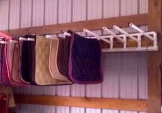 there are many different colors of cloth hanging on the rack