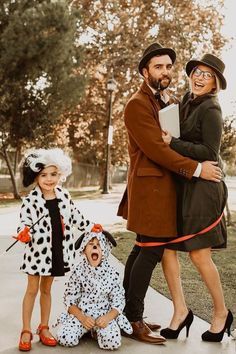 three people dressed up in costumes posing for a photo with one woman and the other man