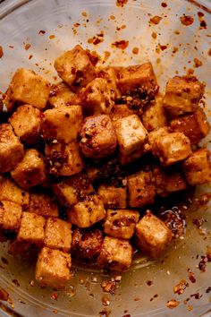 a glass bowl filled with tofu and seasoning