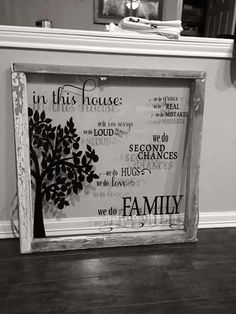 a framed family tree with the words in this house on it's back side