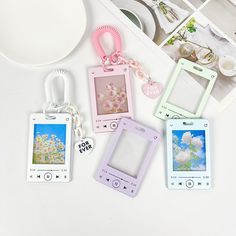 four different styles of cell phones sitting on top of a white table next to each other