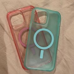 two plastic cases sitting on top of a bed