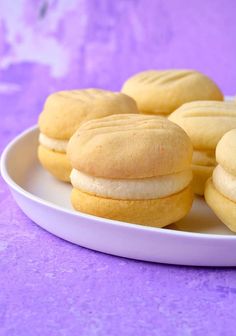 a plate filled with cookies on top of a purple table