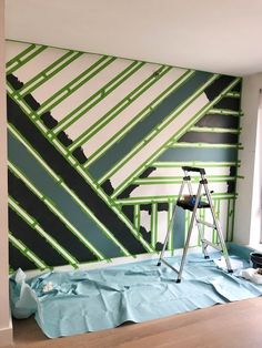 a room that has been painted with green and black stripes on it, while the walls are