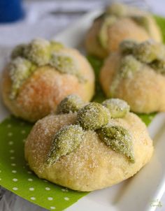 small pastries with green toppings on a plate