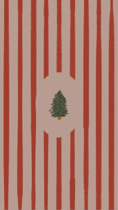 a christmas tree is in the middle of red and white striped wallpaper, with an orange circle at the center