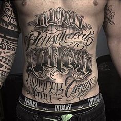 a man with tattoos on his stomach and chest