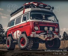 an old red and white van is parked in the dirt