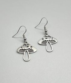 No Tarnish Hypoallergenic ~ Stainless Steel MUSHROOM Pendant Earrings ~ Mushroom Charm ~ Women Teens Jewelry Gift ~ Fun Fashion On The Go * 316L surgical stainless steel (fish hooks);  304 stainless steel (pendants) * Length:  approx 1.5" * Pendants:  25mm x 20mm * Fish hook/ear wires * Tarnish resistant; waterproof MATCHING NECKLACE:   https://www.etsy.com/listing/1714908463/stainless-steel-mushroom-pendant?click_key=9ff5b9b3b2b61bef70c61afd0cbee61194b09ef7%3A1714908463&click_sum=00c9c4fc&ga_search_query=mushroom&ref=shop_items_search_1&sts=1 Please, message me with any questions! All items ship within 24 - 48 hrs (excluding Sundays & holidays). Always adding new items, so please be sure to "heart" my shop!!   THANKS SO MUCH FOR LOOKING!! 🦋 Earrings Mushroom, Mushroom Pendant, Mushroom Earrings, Teen Jewelry, Fish Hooks, Stainless Steel Pendant, Fun Fashion, Matching Necklaces, Fish Hook